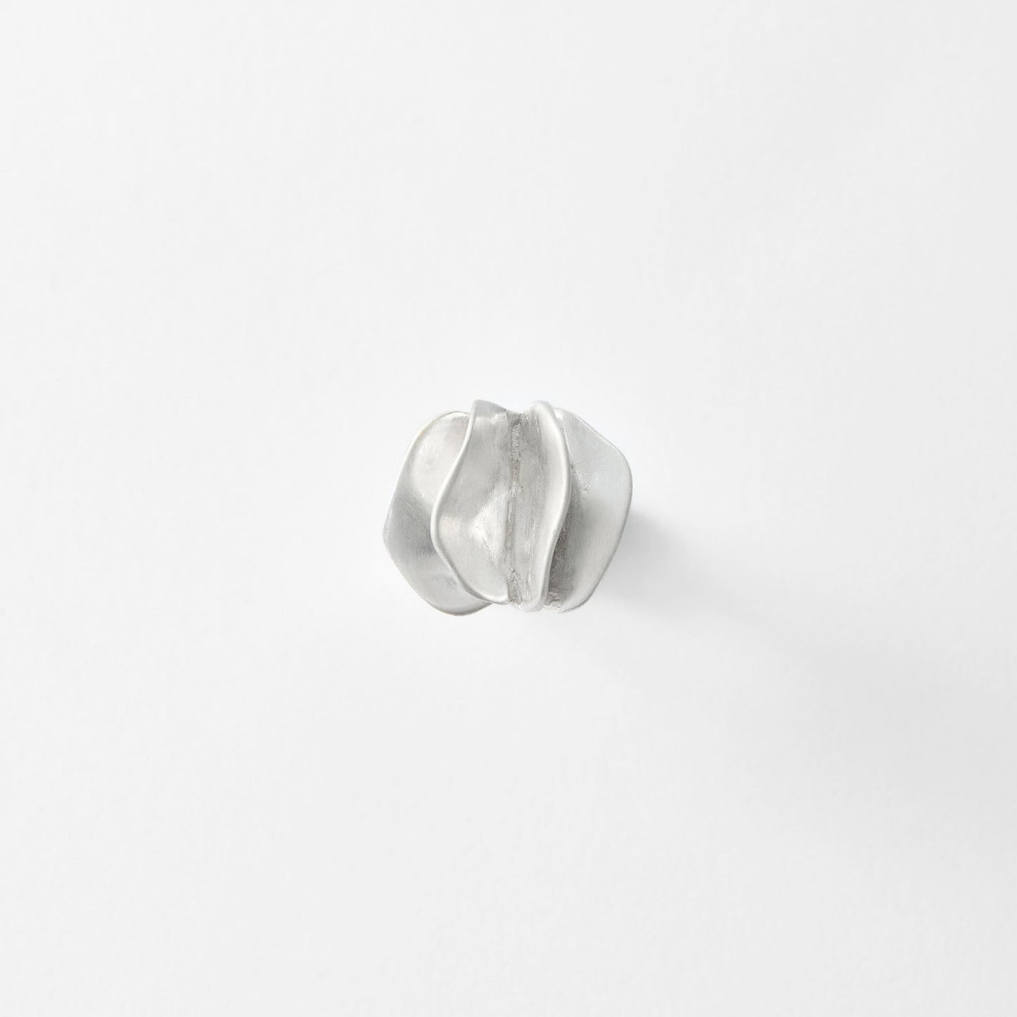 Silver ring on a light gray background