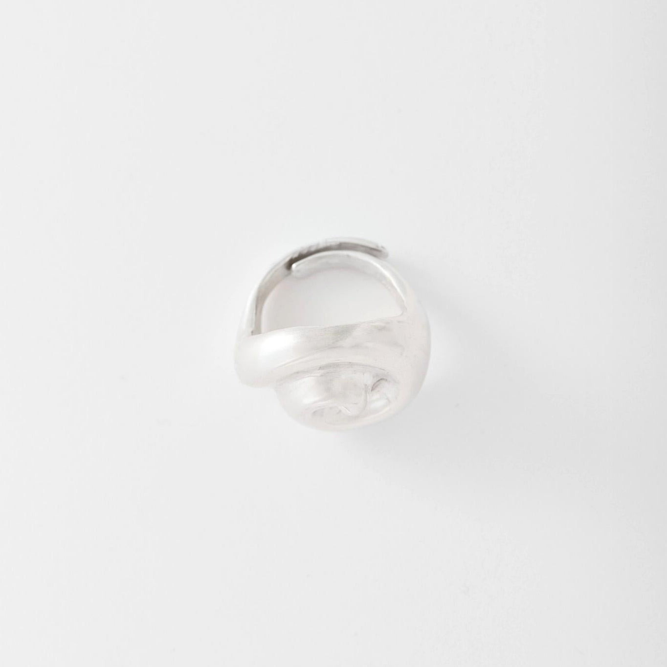 Silver ring on a light gray background