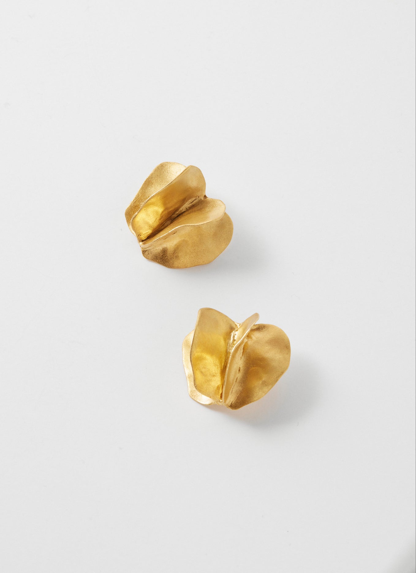 Woman laughing, wearing gold earrings