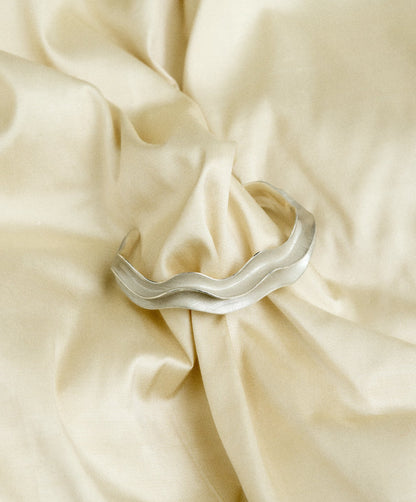 Silver bracelet on fabric