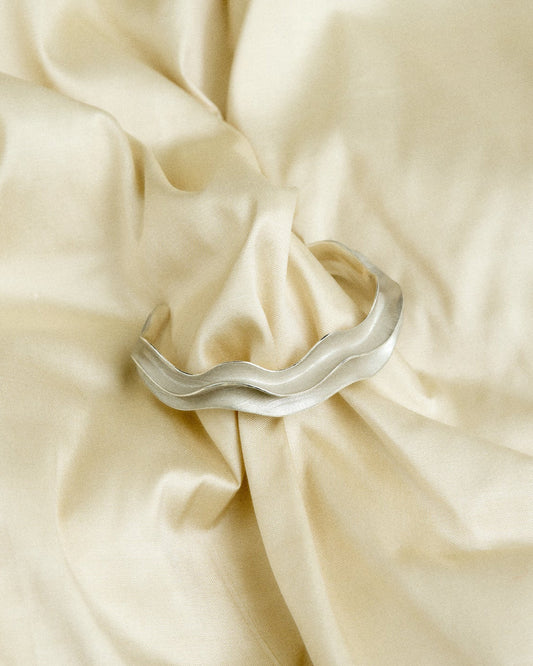 Silver bracelet on fabric