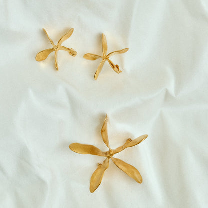 Gold jewelry on a white fabric background