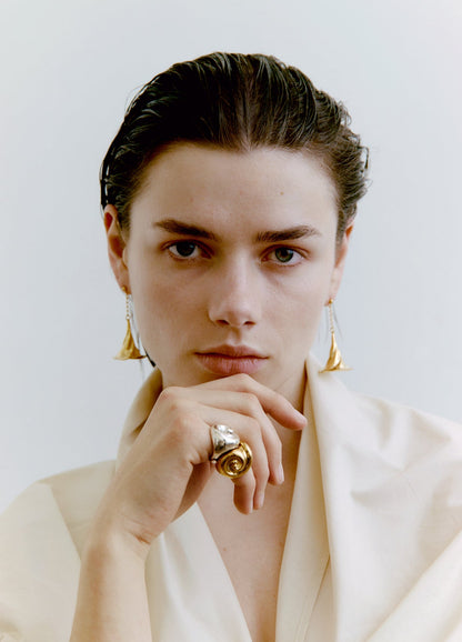 Woman wearing jewelry against a plain background