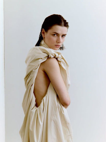 Woman wearing silver earrings against a white background