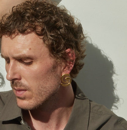 Model wearing gold earring