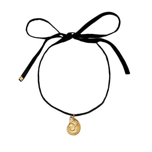 Gold pendant with black silk ribbon