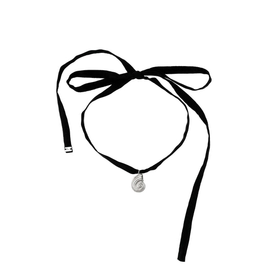 Small silver pendant with black silk ribbon