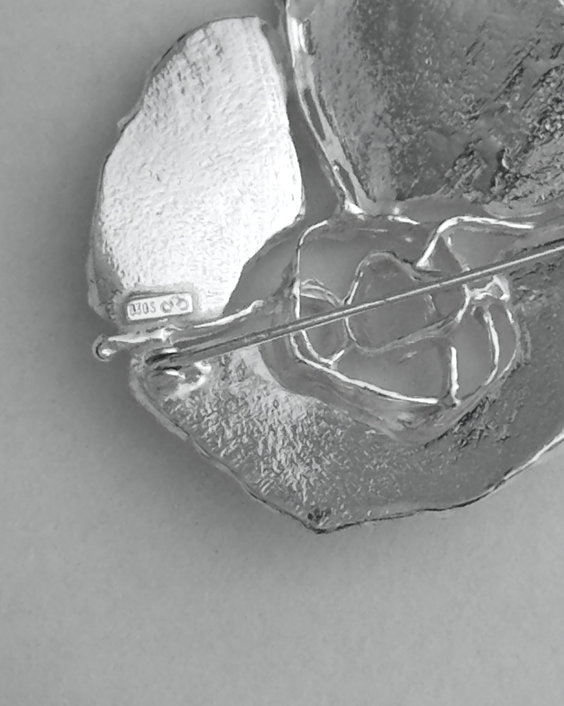 Close-up of a silver brooch