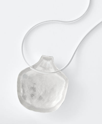 Necklace with a large, textured pendant on a white background