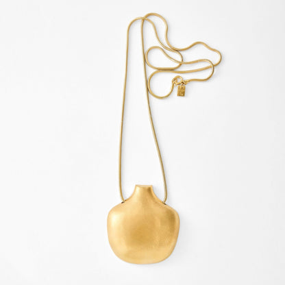 Gold necklace with a pendant on a white background