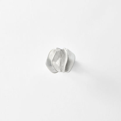 Silver ring on a light gray background