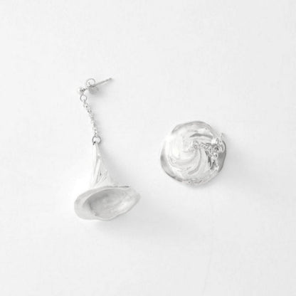 Pair of silver earrings on a light gray background