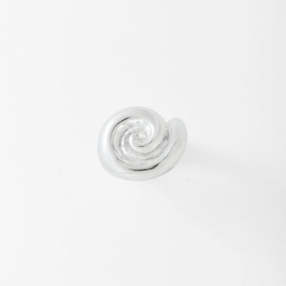 Silver spiral ring on a light gray background