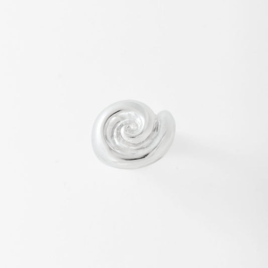 Silver spiral ring on a light gray background