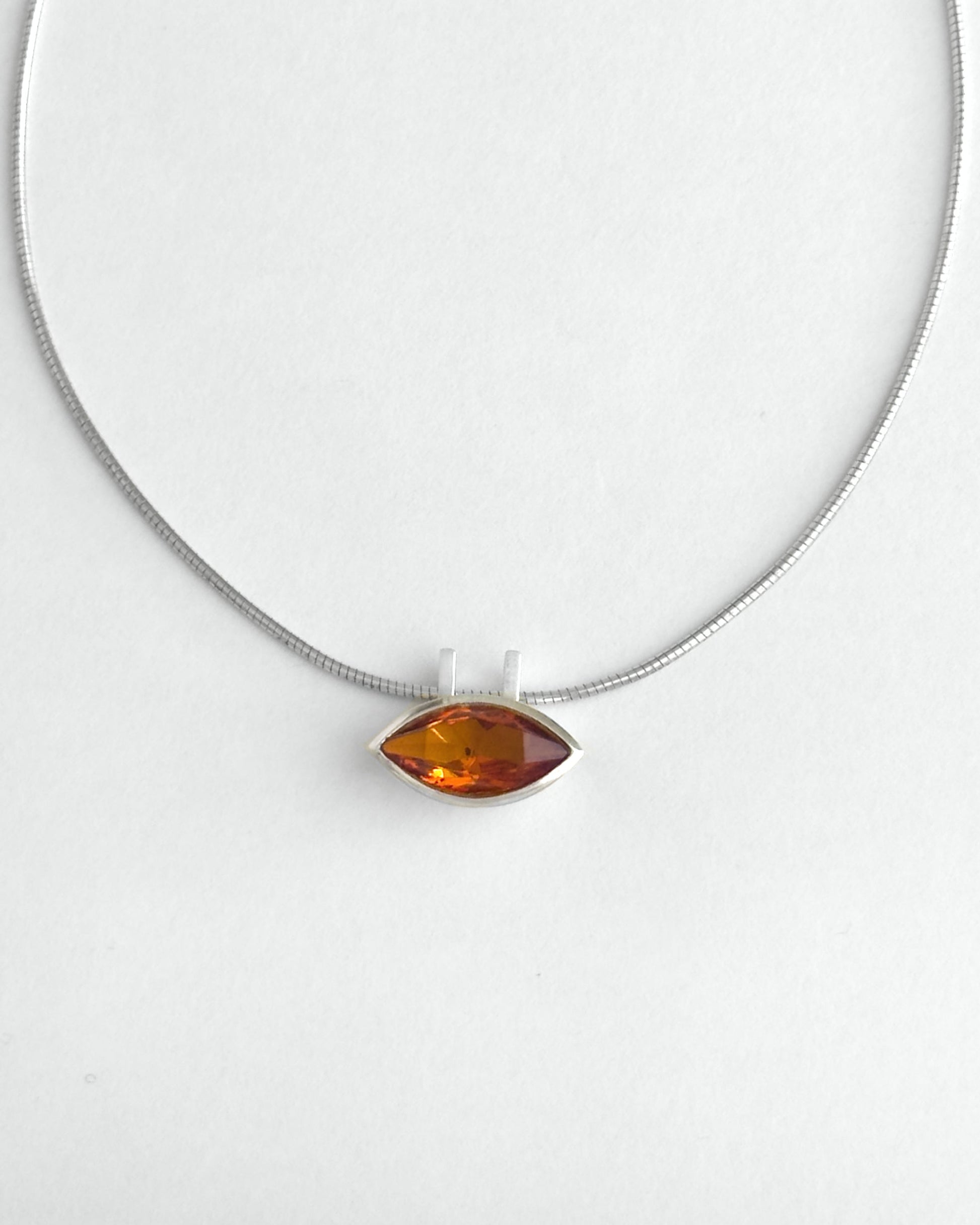 Necklace with a citrine pendant on a white background