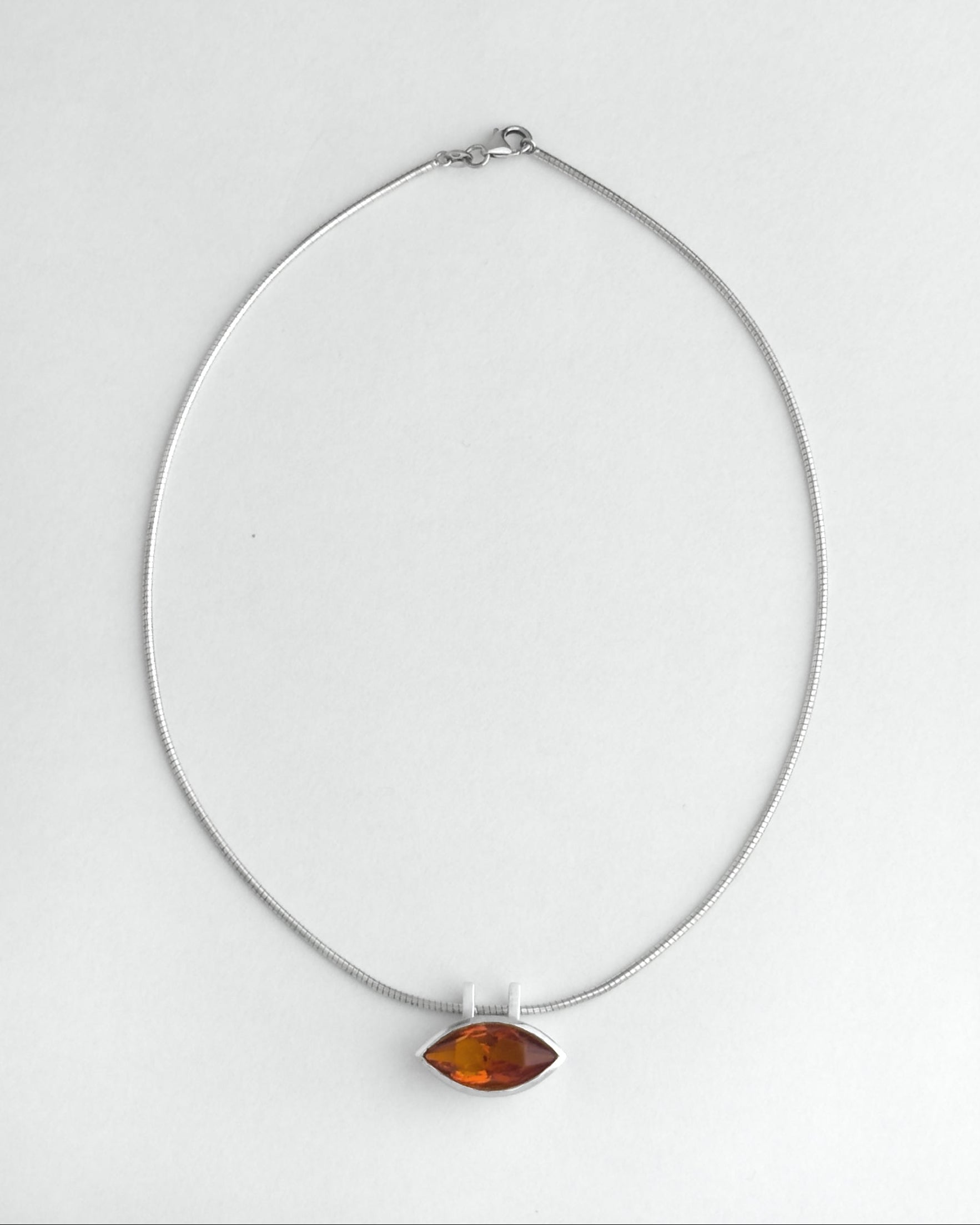 Necklace with a citrine pendant on a white background