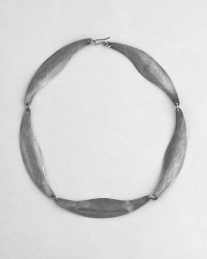 Pewter necklace on a light gray background