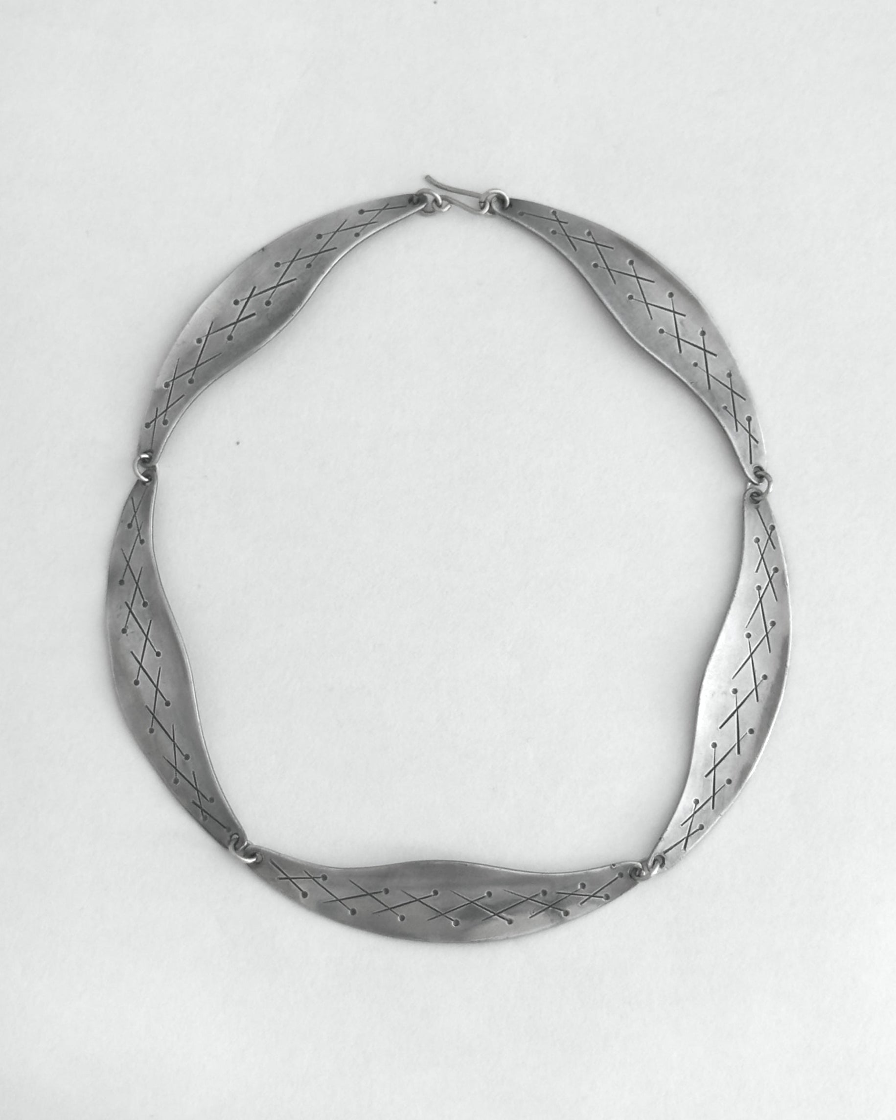 Pewter necklace on a light gray background