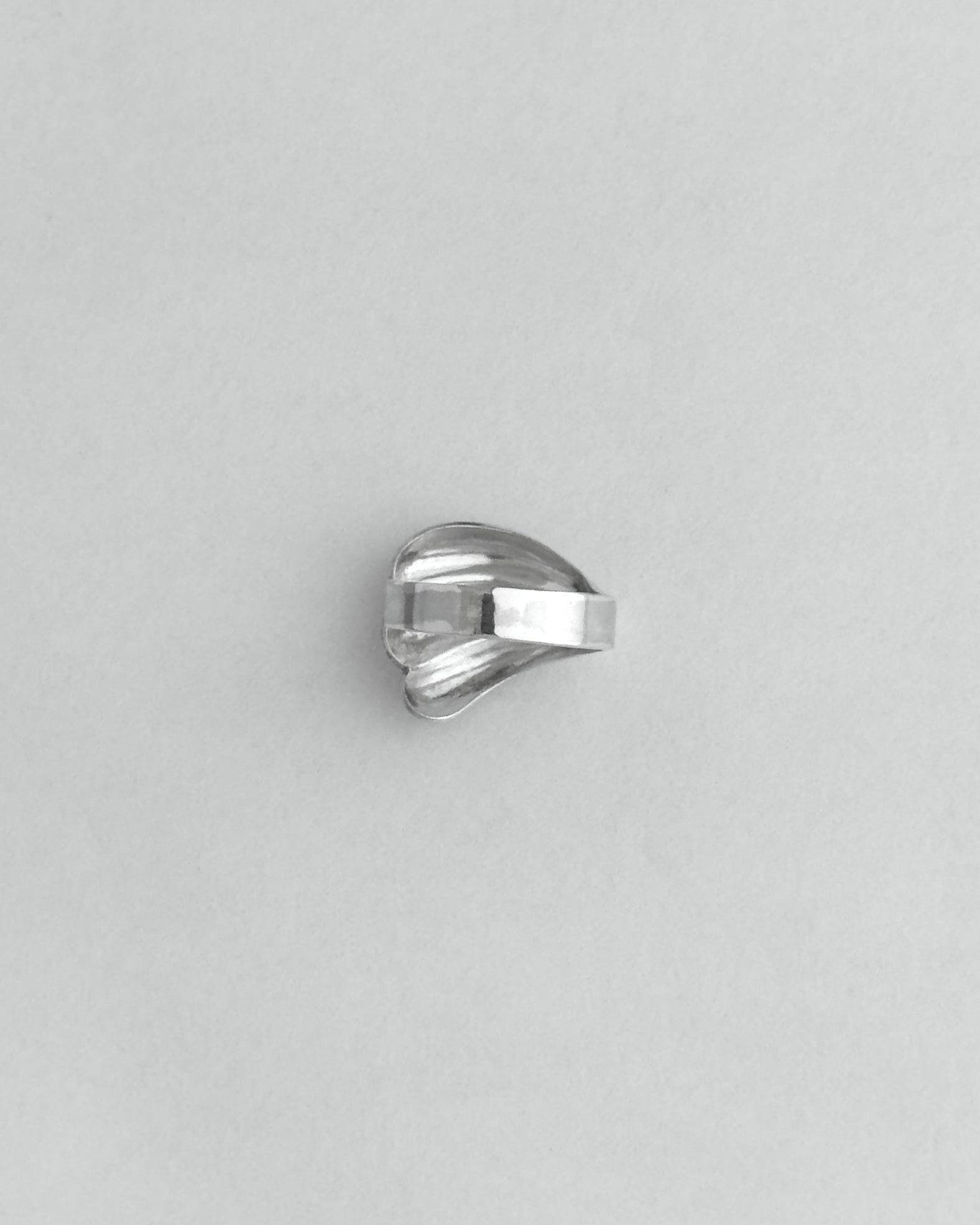 Silver ring on a light gray background
