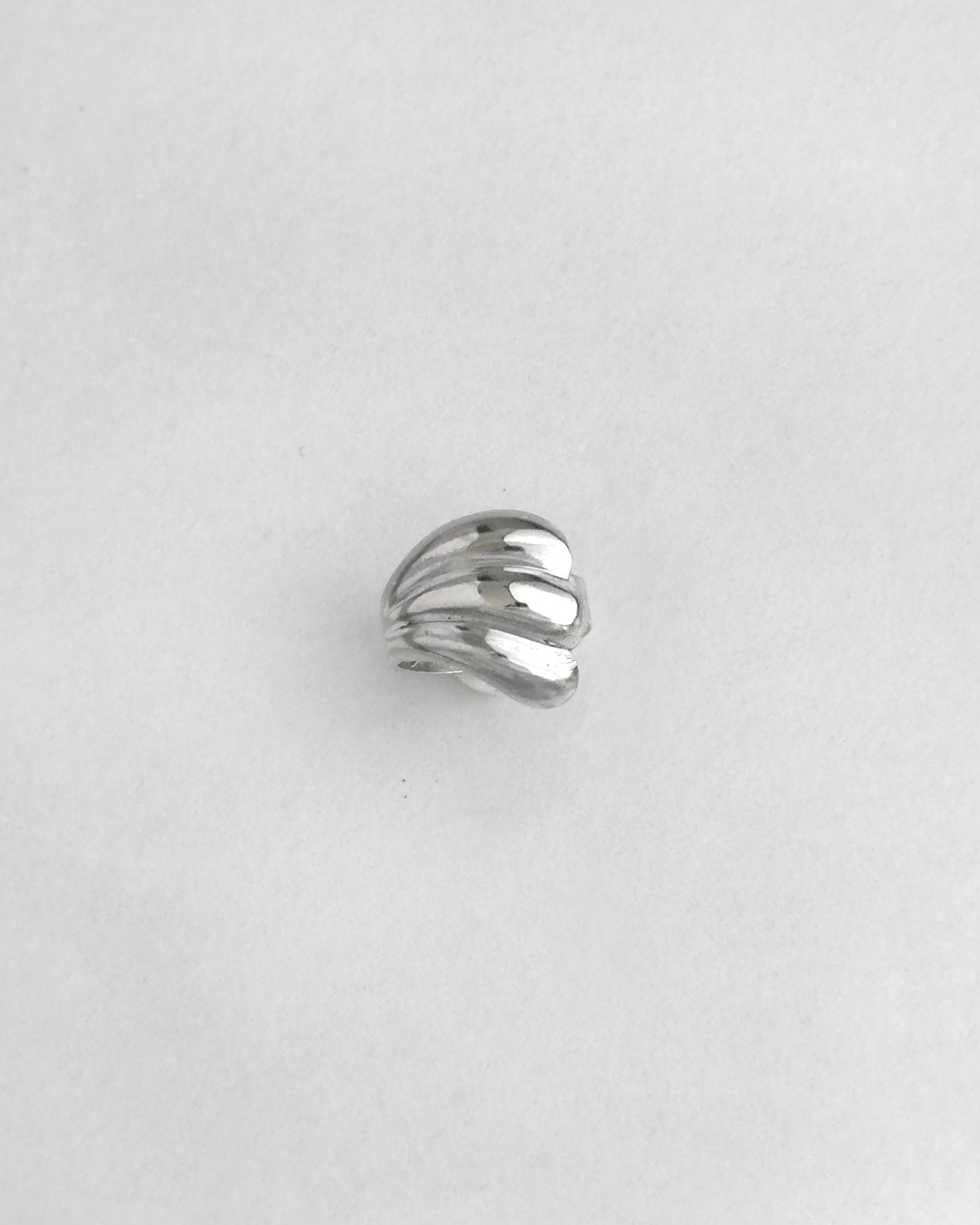 Silver ring on a light gray background