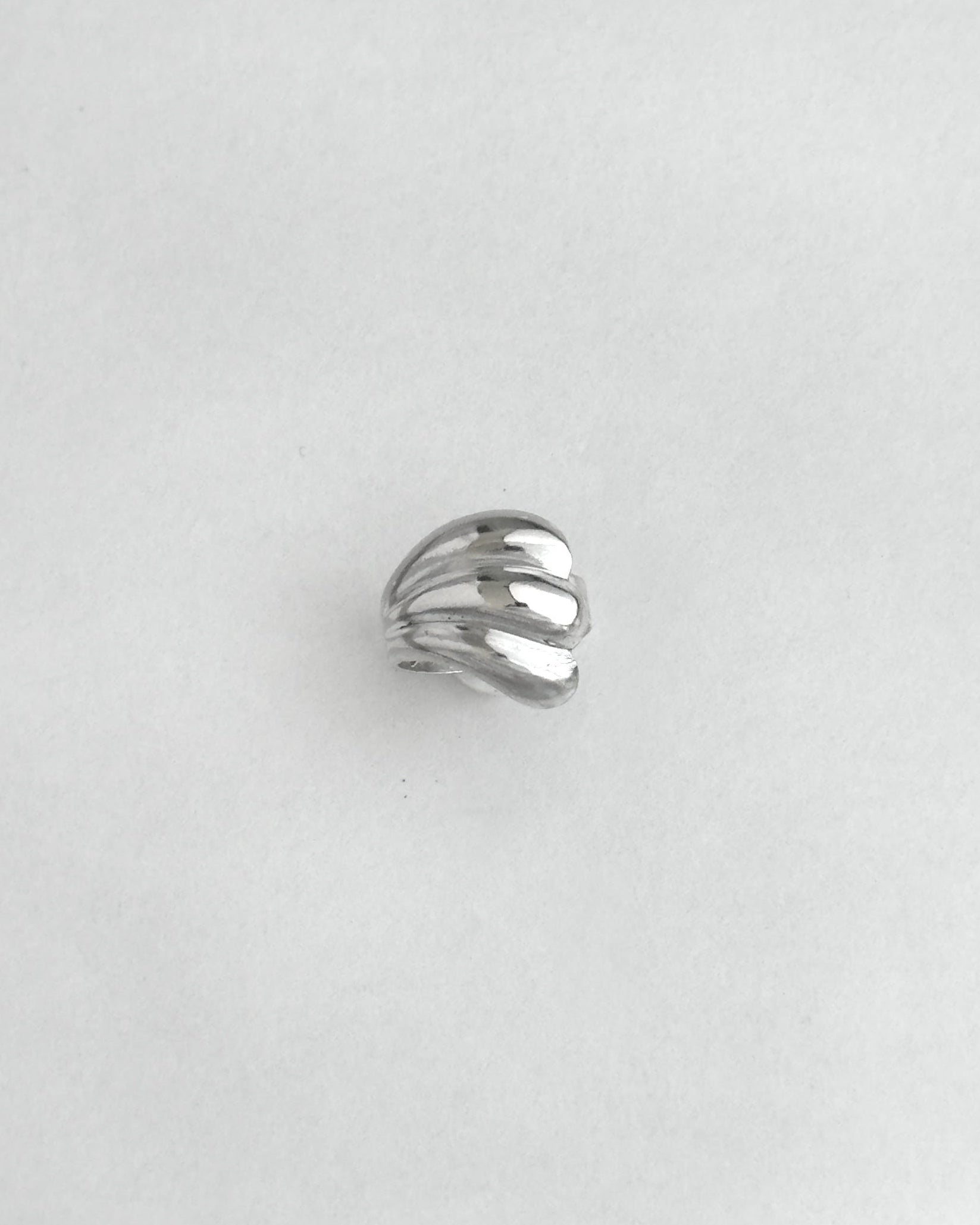 Silver ring on a light gray background