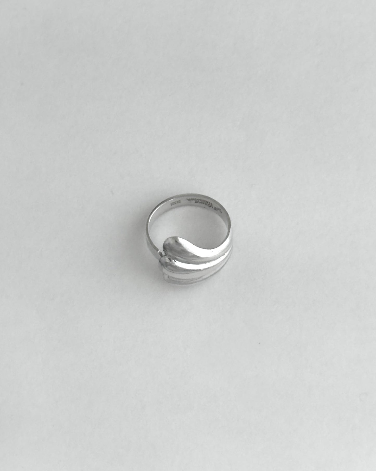 Silver ring on a light gray background