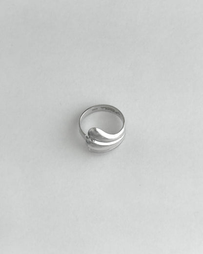 Silver ring on a light gray background
