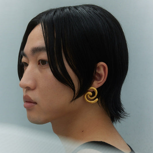 Model wearing gold earring