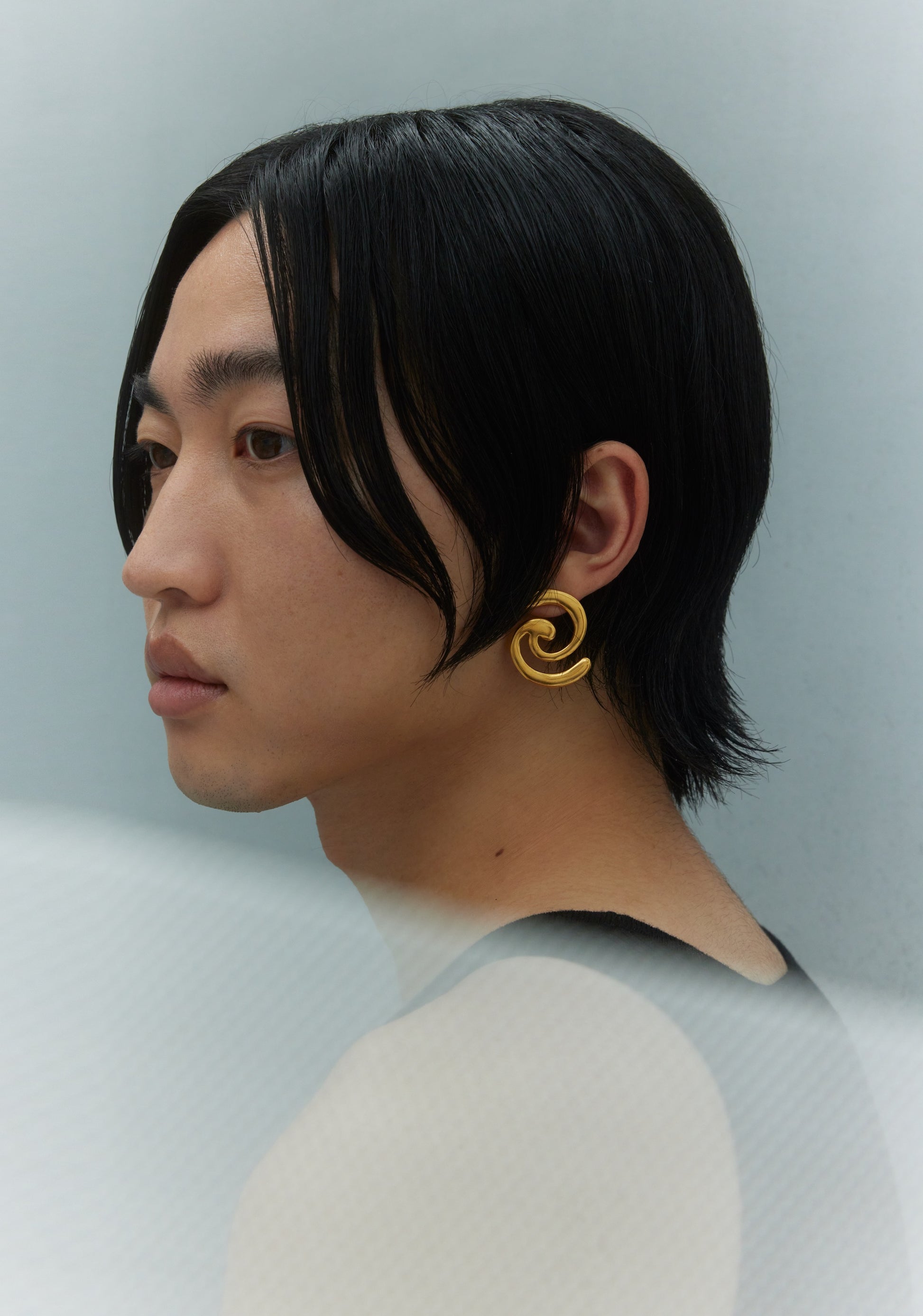 Model wearing gold earring
