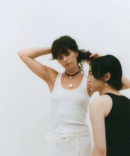 Two models poses, wearing silver jewelry