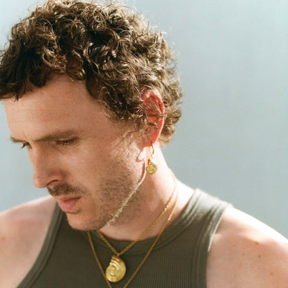 Model wearing gold jewelry