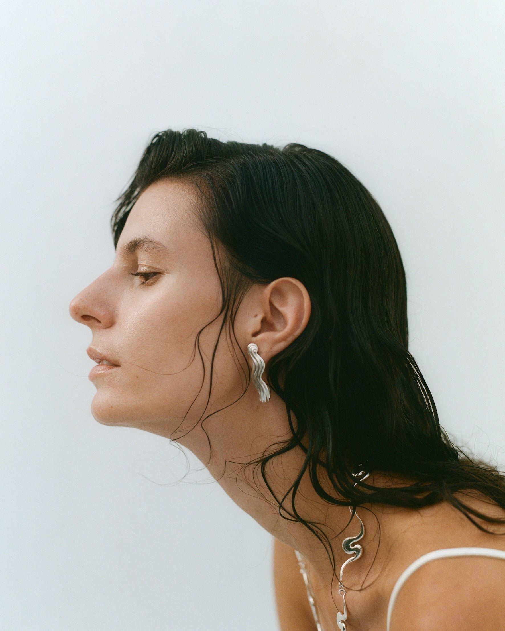 Female models profile, wearing silver jewelry