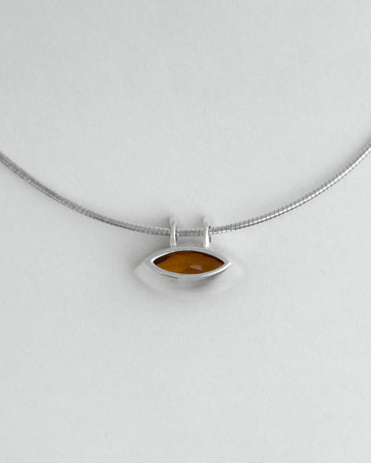 Silver necklace with a citrine pendant on a light gray background