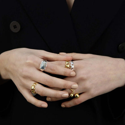Female hands held together, wearings many rings
