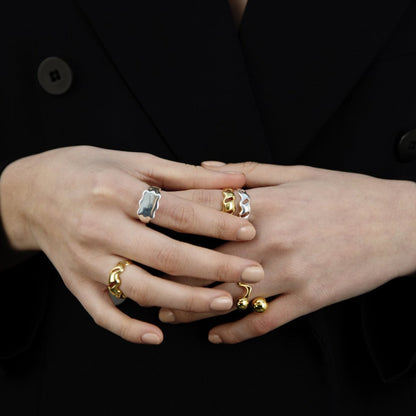 Female hands held together, wearings many rings