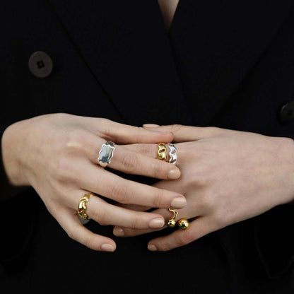 Female hands held together, wearings many rings