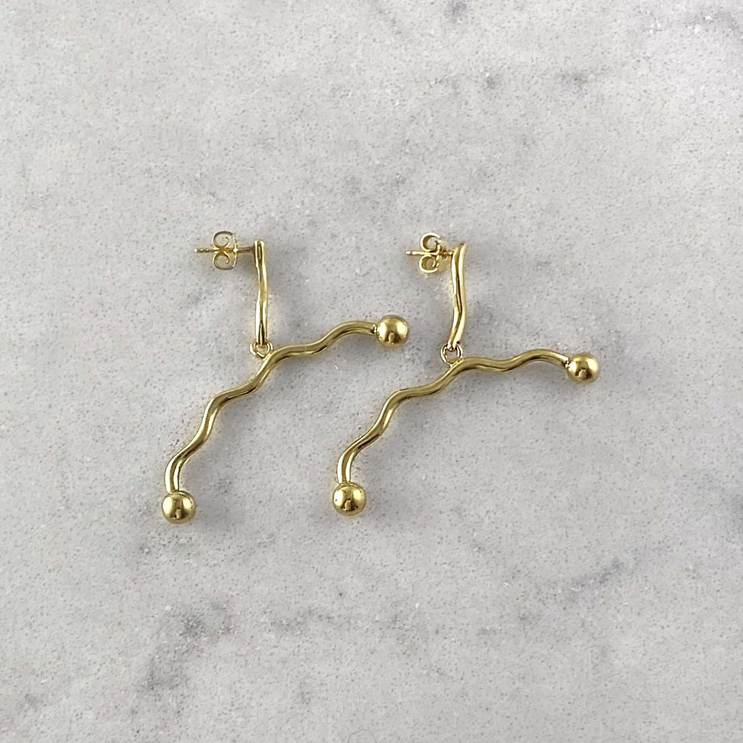 Product photo of gold plated earrings by Aur Studio