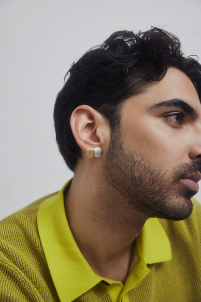 Profile of a man wearing jewelry