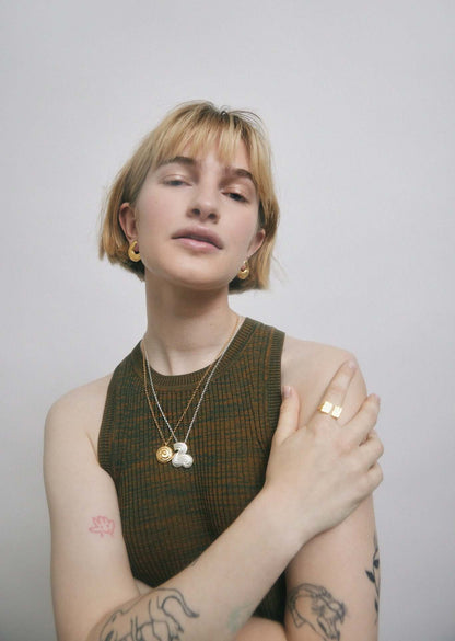 Woman in green top wearing jewelry