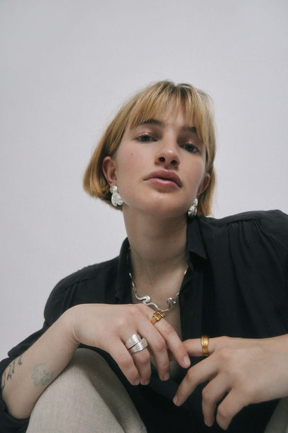 Woman wearing jewelry in gold and silver