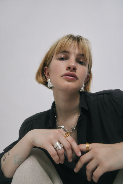 Woman wearing jewelry in gold and silver