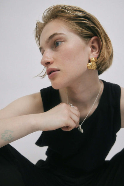 Woman wearing jewelry, looking away