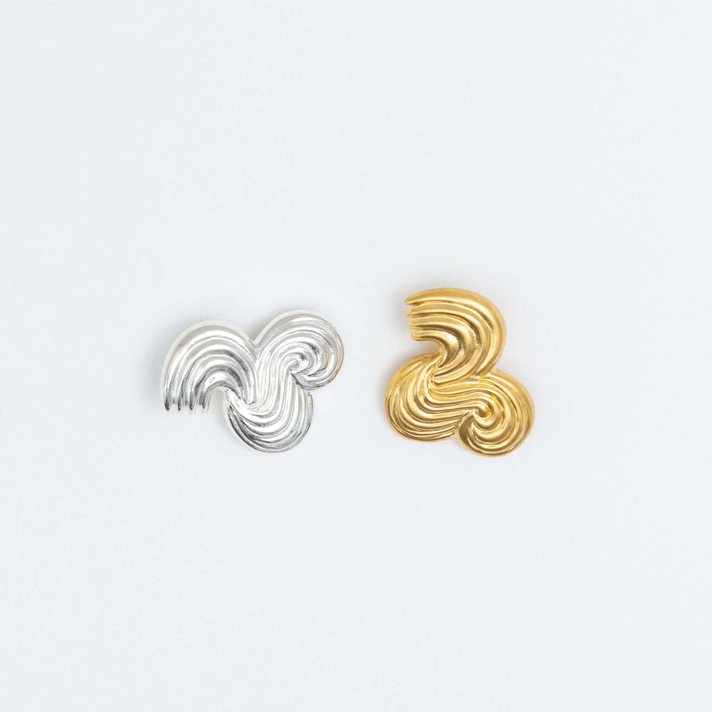 One silver and one gold earring, same design
