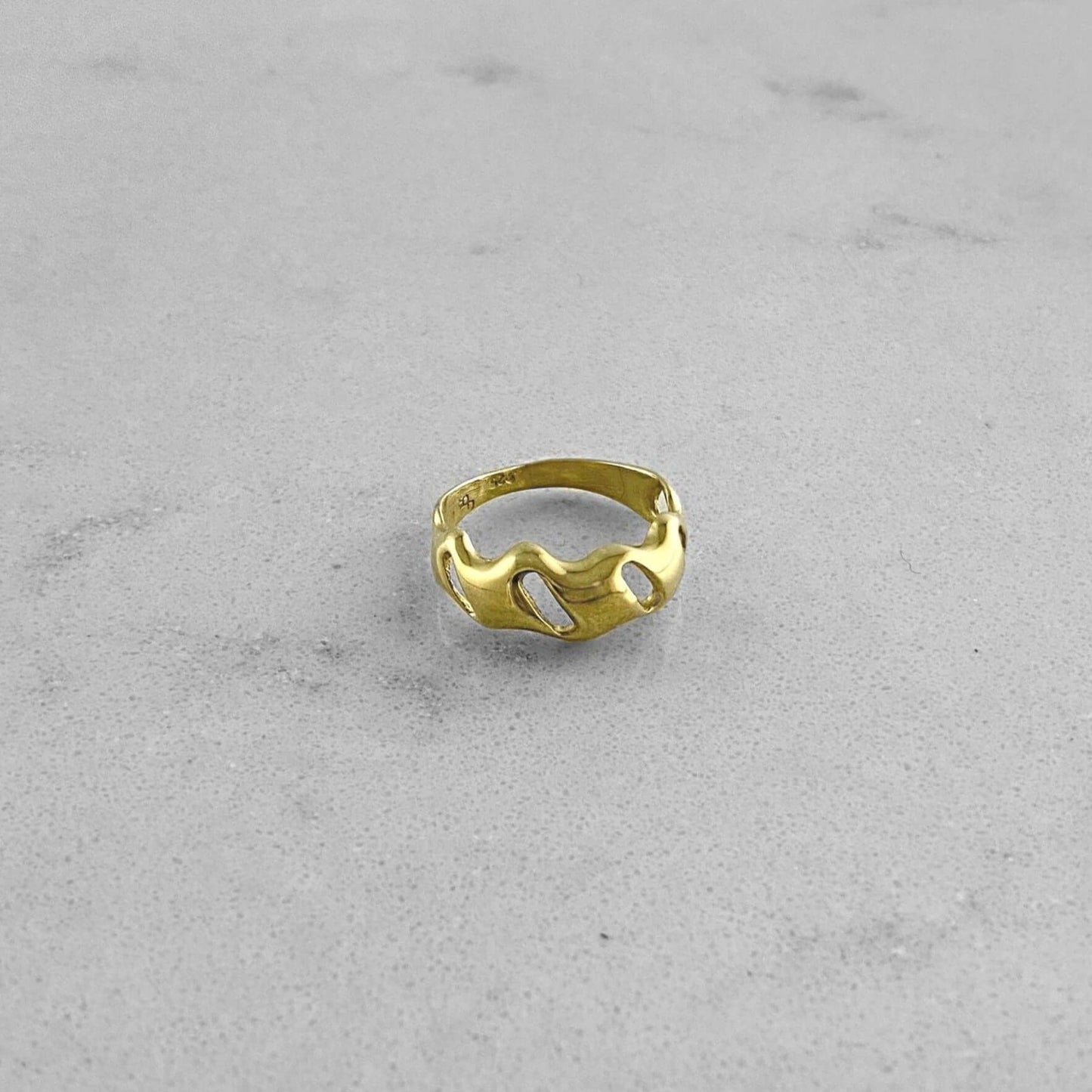 Product photo of a gold ring by Aur Studio