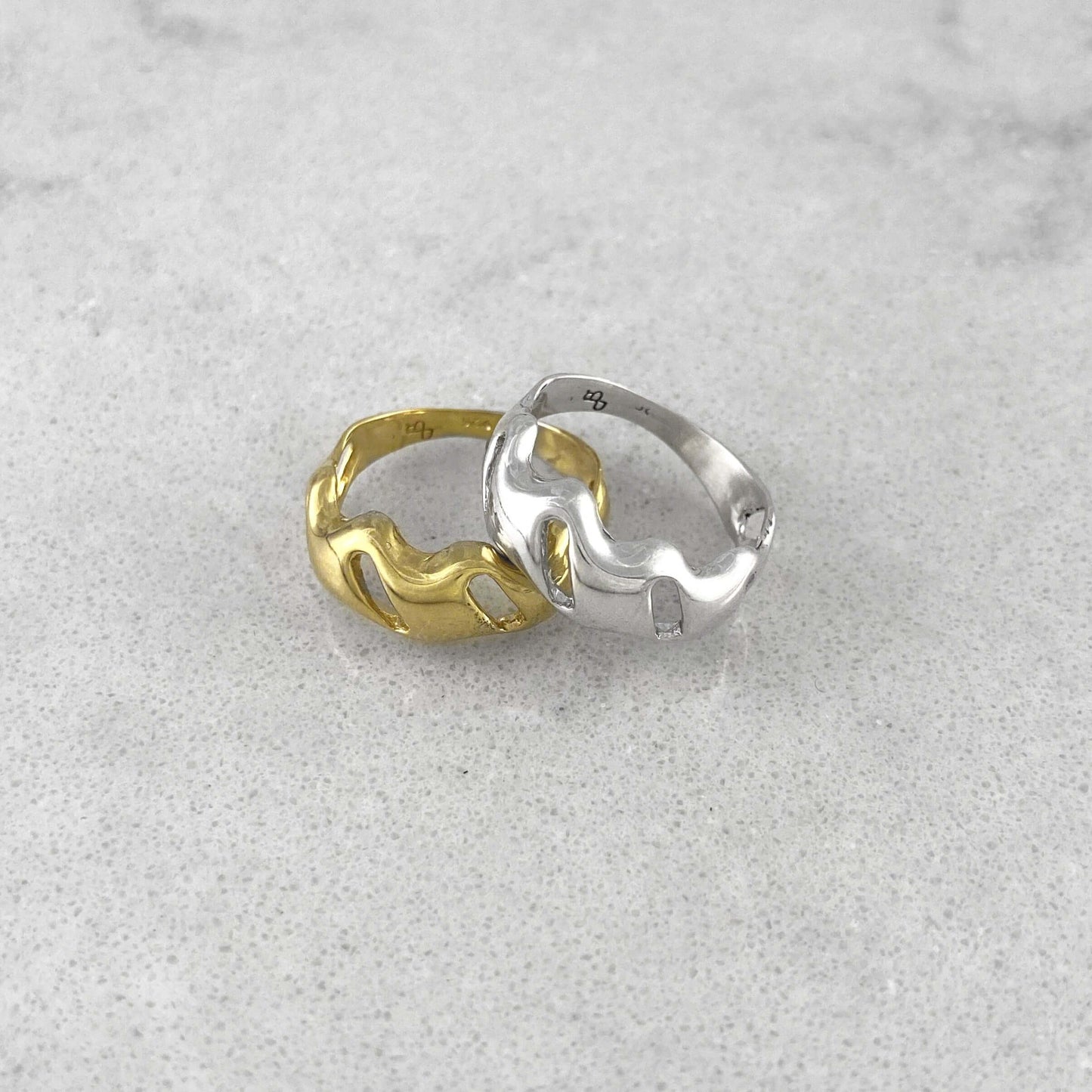Product photo of two rings, one in silver and one in gold
