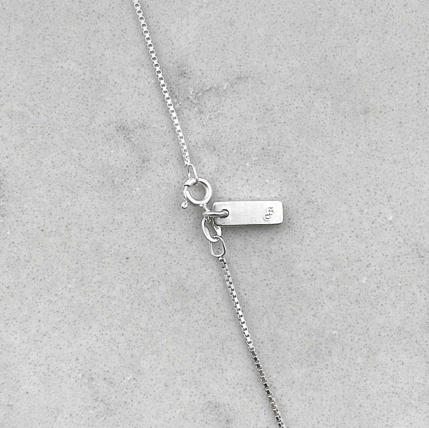 Close up on details of a silver necklace