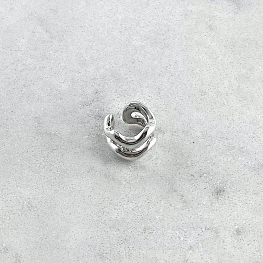Silver ear cuff on a marble table