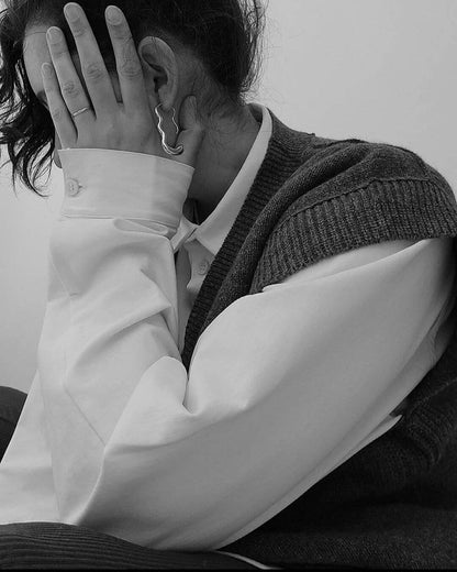 Woman in white shirt with silver earring