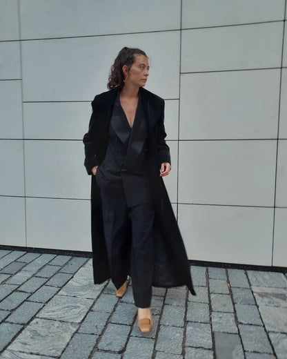Woman wearing dark coat and silver earrings