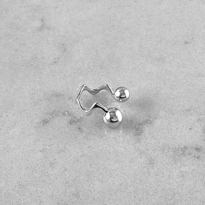 Product photo of a silver ring laying on a marble plate